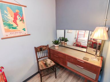 A dressing table with a mirror and chair at Grain Store near Narberth