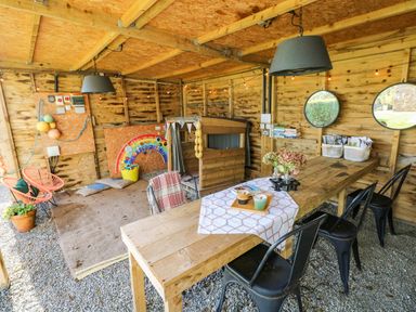 A garden room with a table and chairs at Grain Store near Narberth