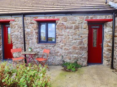 An outdoor area with a table and chairs at Cattle Shed near Narberth