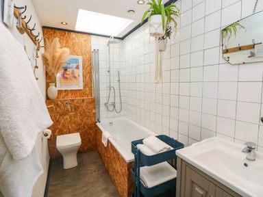 A bathroom with a bathtub, sink, and toilet at Cattle Shed near Narberth