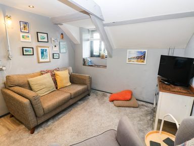 A living room with a sofa and TV at Hayloft near Narberth