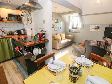 A kitchen and living area with dining table and sofa at Hayloft near Narberth