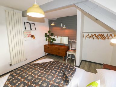 A bedroom with a bed and dresser at Hayloft near Narberth