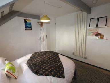 A bedroom featuring a bed and decorative items at Hayloft near Narberth