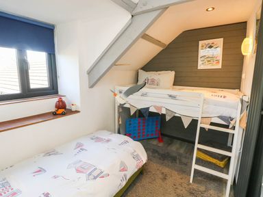 A bedroom with a loft bed and a toy car at Hayloft near Narberth