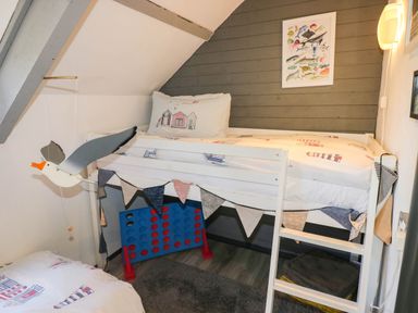 A bedroom with a bunk bed and a game board at Hayloft near Narberth