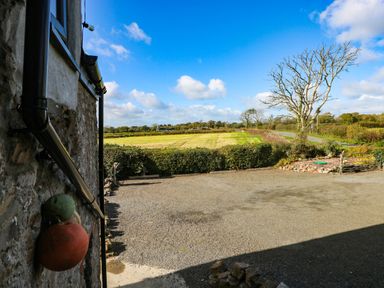 An outdoor area with a view of fields and trees at Hayloft near Narberth