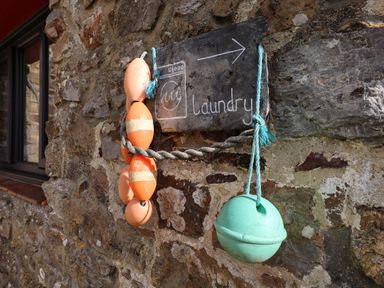 A laundry sign attached to a stone wall at Hayloft near Narberth