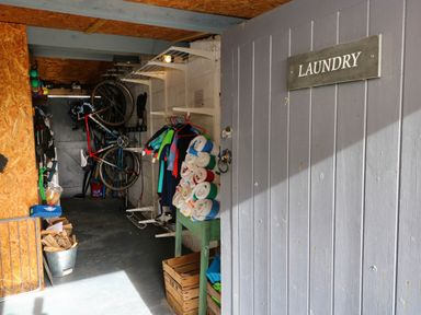 A laundry room with bicycles and hanging clothes at Milking Shed near Narberth