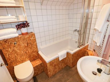 A bathroom with a bathtub and a sink at Milking Shed near Narberth