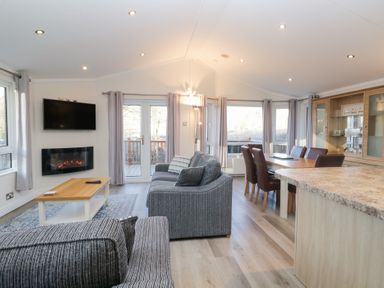 A living room with a sofa and dining area at Heights View in 