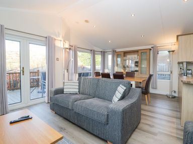A living room with a sofa and dining area at Heights View