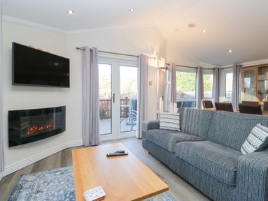 A living room with a television and fireplace at Heights View