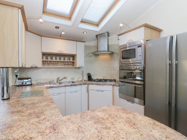 A kitchen with appliances including a refrigerator and stove at Heights View