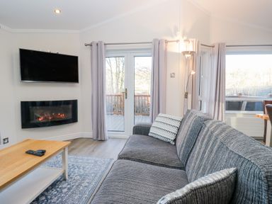 A living room with a television and fireplace at Heights View