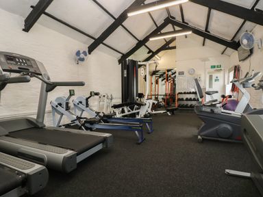 An indoor gym with treadmills rowing machines exercise bike weight racks and resistance machines at Dartmoor 2 in Callington
