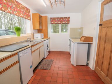 A kitchen with countertop appliances including microwave dishwasher and washing machine at West Burnbank in Tarset near Bellingham