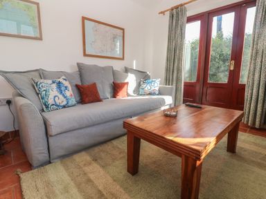 A living room with a sofa and coffee table at Kernyk in Penzance
