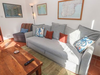 A living room with a sofa and armchair at Kernyk in Penzance