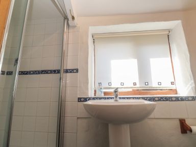 A bathroom with a shower and a sink at Kernyk in Penzance