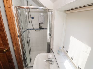 A bathroom with a shower and sink at Kernyk in Penzance