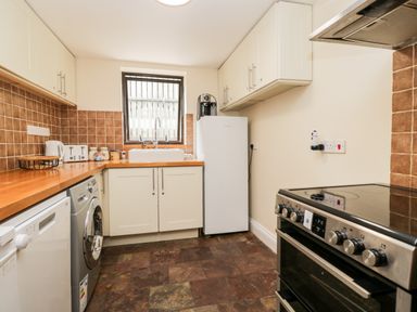 A kitchen with appliances and countertops at The Barn in Draycot Cerne near Malmesbury