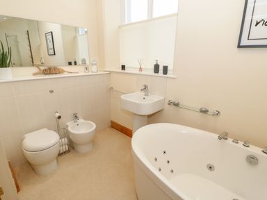 A bathroom with a toilet bidet sink and bathtub at Seion Chapel in Beaumaris