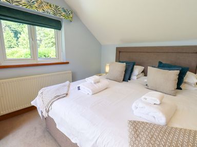 A bedroom with a bed and two pillows at Waterhead Cottage in Ecclerigg, near Troutbeck Bridge