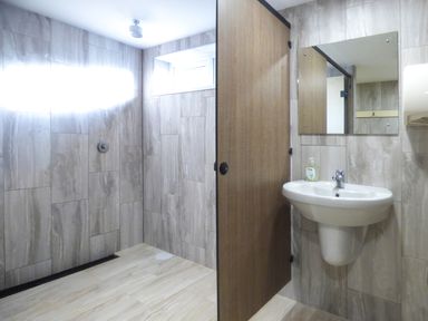 A bathroom with a walk-in shower and a basin with mirror at Hazel Cottage in Poughill near Bude