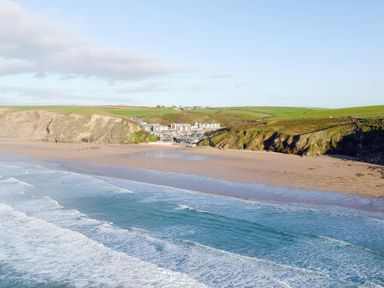 A beach with cliffs and houses at 28 Zenith in Porth