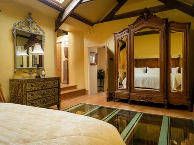 A bedroom with a bed and antique furniture at The Meeting House in Ashburton