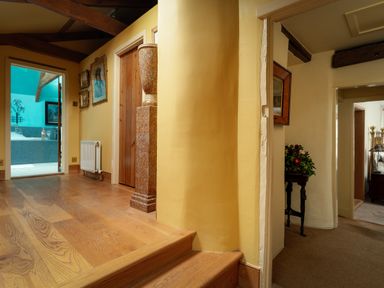 A hallway with stairs and a vase at The Meeting House in Ashburton
