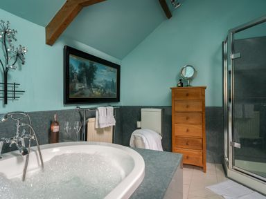 A bathroom with a bathtub and shower at The Meeting House in Ashburton