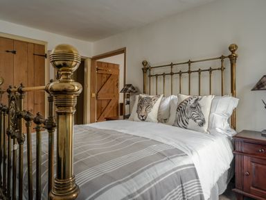 A bedroom with a bed and wardrobe at The Meeting House in Ashburton