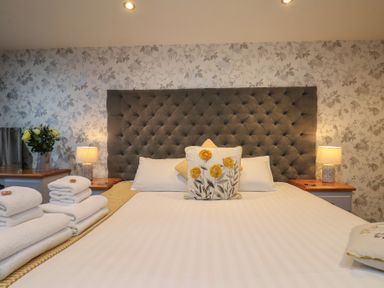 A bedroom with a bed and bedside table at Premier, Transit &amp; Lady Hilda @ Engine Shed, Whitby