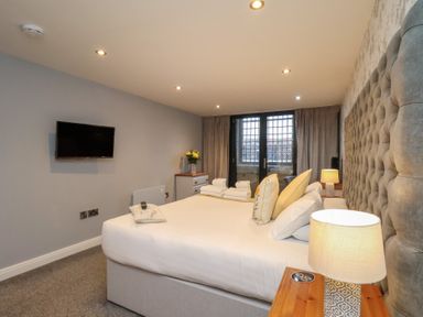 A bedroom with a bed and television at Premier, Transit &amp; Lady Hilda @ Engine Shed, Whitby