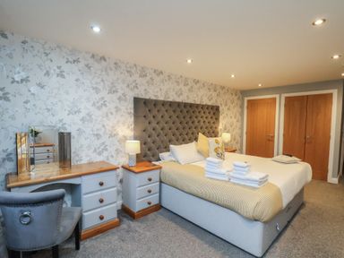 A bedroom with a bed and nightstand at Premier, Transit & Lady Hilda @ Engine Shed, Whitby