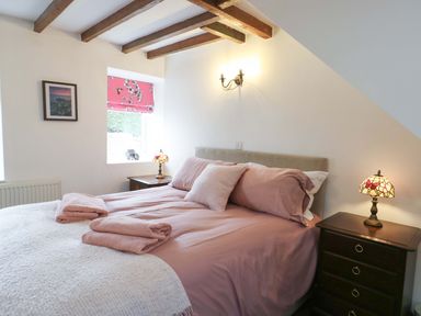 A bedroom with a bed and nightstand at Ael Y Bryn in Menai Bridge