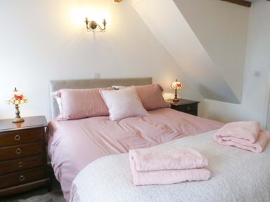A bedroom with a bed and bedside lamps at Ael Y Bryn Menai Bridge