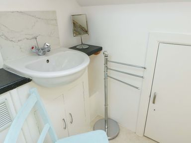A bathroom with a sink and mirror at Ael Y Bryn Menai Bridge