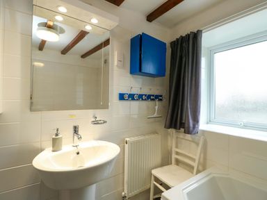 A bathroom with a sink and mirror at Ael Y Bryn in Menai Bridge
