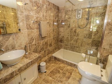 A bathroom with a toilet sink shower and towel rack at Cottage on the Common in Westbury-on-Severn