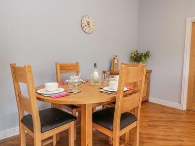 A dining area with a wooden table set for four with bowls glasses and cutlery in Coal Drops Alnwick