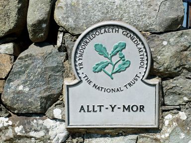 A stone wall with a National Trust plaque that reads Allt-y-Mor