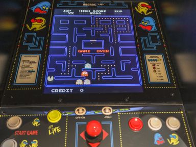 An arcade game console showing a game over screen of a maze game with joystick and buttons at Flip Flops in Rhosneigr