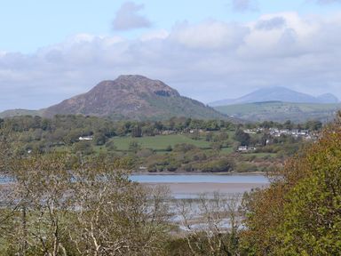 A landscape with hills trees a body of water and houses at Big House in Llandecwyn