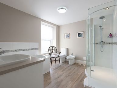 A bathroom with sink, toilet, and shower at West View, Rhosneigr