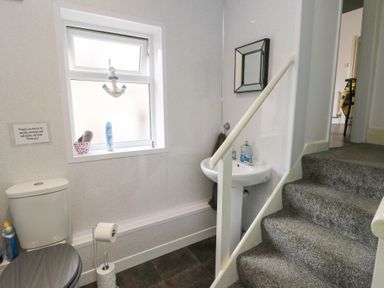 A bathroom with toilet and sink at Sea Breeze in Rhos-on-Sea