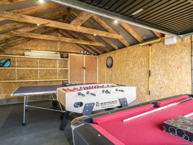 A game room with a pool table foosball table and ping pong table at The Coach House in Teignmouth