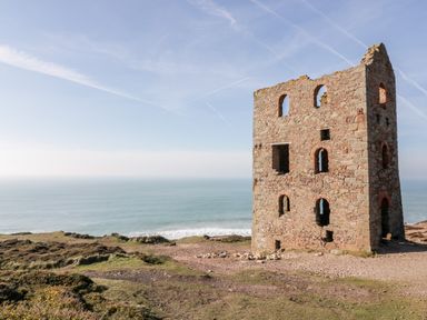 A stone building ruin on a cliff overlooking the ocean at Avalon in St Agnes